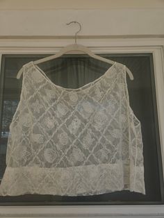 Seashell lace tank top. Would make a super cute beach cover-up! Dimensions:  Width: 23" Length: 18" To ensure a good fit, I recommend comparing these measurements to a tank top that fits you well. Summer Cotton Lace Top, Casual Cotton Lace Top For Summer, Summer Cotton Lace Top With Lace Patchwork, Sheer Lace Camisole Top, Delicate Lace Top For Summer, Sheer Summer Top For Beach Cover-up, Summer Sheer Tops For Beach Season, Sheer Summer Top For Beach, Summer Delicate Lace Cami Top