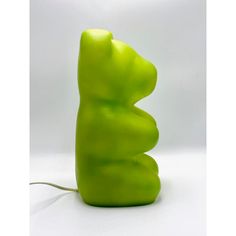 a green lamp shaped like a bear on a white background