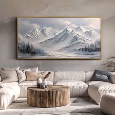 a living room with a large painting on the wall and white couches in front of it