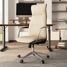 a white office chair sitting in front of a computer monitor on top of a desk