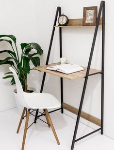 a white chair sitting in front of a desk with a wooden shelf on top of it