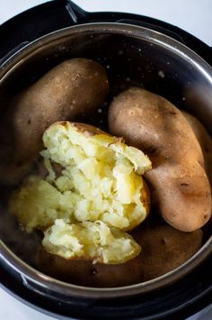 potatoes in an electric pressure cooker, with the top half peeled and the other half uncooked