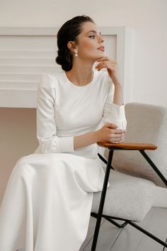 a woman in white sitting on a chair