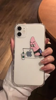 a person holding an iphone case with a sticker on it