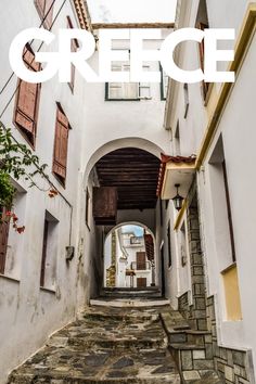 an alley way with stone steps leading up to the door