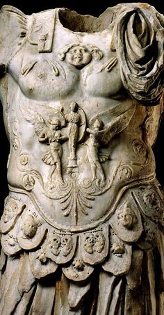 an ancient statue with intricate designs on it's body and torso, in white marble