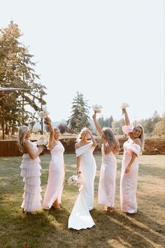 the bridesmaids have their arms in the air