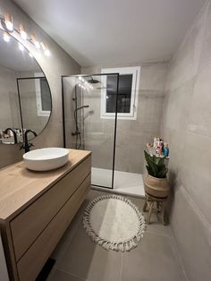 a bathroom with a sink, mirror and bathtub next to a shower stall in the corner