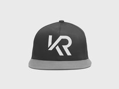 a black and grey hat with the letter r in white on it's peak