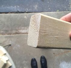 a person holding a piece of wood in their hand