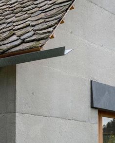 a close up of a building with a metal gutter