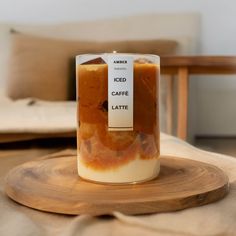 a glass jar filled with food sitting on top of a wooden table next to a chair