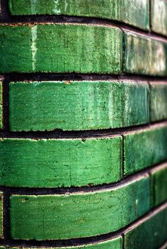 a green brick wall that has been painted