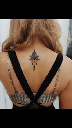 a woman with a cross tattoo on her back