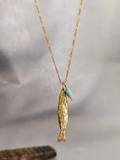 Necklace details:  * The necklace and the pendant made from 14 karats solid yellow gold. * Chain length 20Inch/ 50cm'. * Fish pendant size: 1.3x0.25inch/ 33x6mm. A goldfish necklace with the good eye stone that will lead us on the right path . Chain available in all sizes, color gold and karat and matte or shining finish. Each pendant is custom-made, unique, and will have slight variations in shape. If you want to change something, width, Length, personal engraving, or anything else. Please cont Necklace Unique, Necklace Gold, Goldfish Necklace, Snail Necklace, Gold Fish Jewelry, Fish Pendant, Fish Necklaces Jewelry, Fish Necklace Gold, Gold Fish-shaped Necklace For Gift