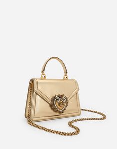 This small top-handle bag from the Devotion line comes in materials that are perfect for special occasions. Made from nappa mordore leather; it features the exclusive bejeweled heart fastening and the shoulder strap inspired by the techniques of high quality jewelers. Top handle and detachable shoulder strap Front flap with bejeweled branded heart hand-tooled from a metal alloy with pearl inlay Concealed magnetic fastening and customized heart Calfskin interior with flat pocket Item comes with i Small Top Handle Bag, Pearl Inlay, Gold Bag, Jewelry Techniques, Heart Hands, Gold Leather, Handle Bag, Nappa Leather, Small Tops