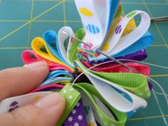 a person is holding some colorful hair clips