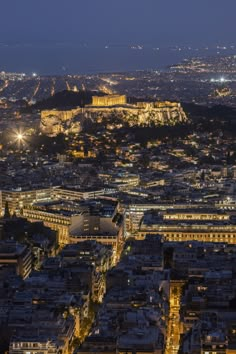 an aerial view of paris at night with the eiffel tower in the background