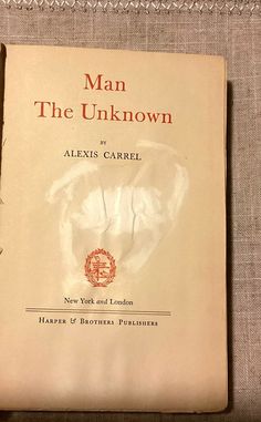 an old book with the title man, the unknown written in red on it's cover