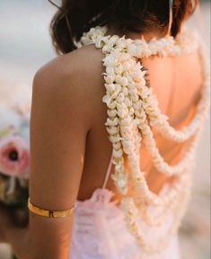 the back of a woman's dress with flowers on it