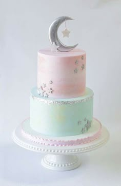 a three tiered cake decorated with stars and moon