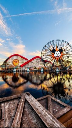 an amusement park with a ferris wheel and mickey mouse