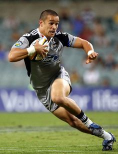 a rugby player is running with the ball