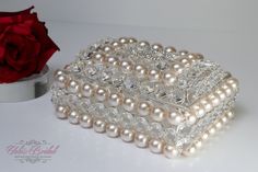 a close up of a box with pearls on it