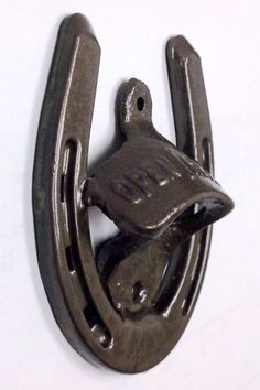 a metal hook with a bird on it's side hanging from a wall or door