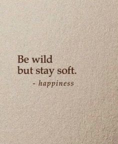 a white wall with a quote on it that says, be wild but stay soft happiness