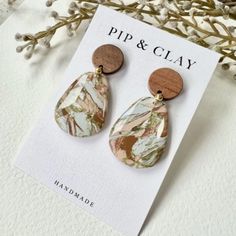 a pair of earrings sitting on top of a card