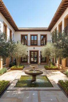 an outdoor courtyard with fountain and trees