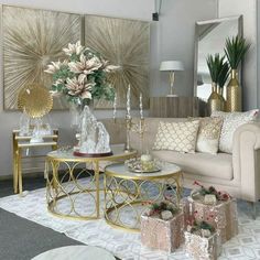 a living room filled with lots of furniture and flowers on top of a coffee table