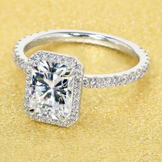 a cushion cut diamond ring with pave set shoulders