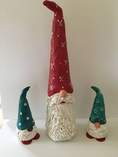 three gnomes are standing next to each other