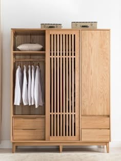 a wooden cabinet with clothes hanging on it