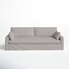 a gray couch sitting on top of a white floor