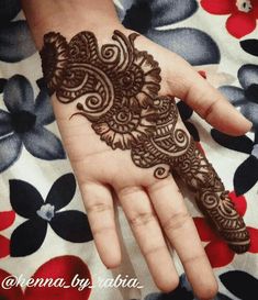 the hand is decorated with henna on it