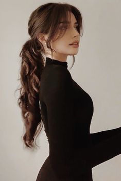 a woman with long hair wearing a black dress