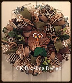 a wreath with an owl and leaves on it