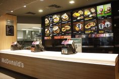 mcdonald's fast food restaurant counter with menus on the wall and coffee machines