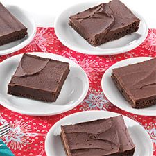 six pieces of chocolate cake sitting on plates with forks and napkins next to them