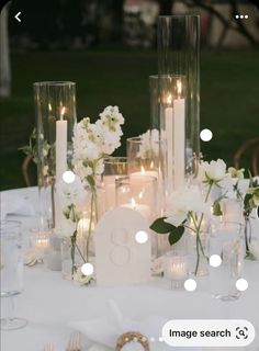 a table with candles and flowers on it