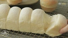 a person is holding some bread on a wire rack and it looks like they are going to make something