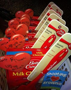 valentine's day chocolates are lined up in a basket with hearts on them