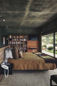 a bedroom with a large bed and lots of bookshelves