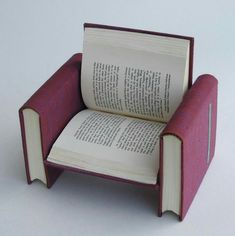 an open book sitting on top of a chair