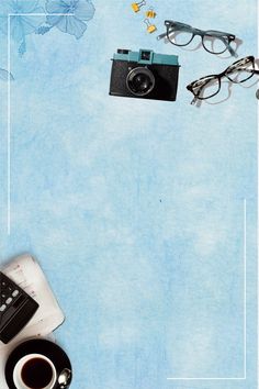 an overhead view of a camera, coffee cup and eyeglasses on a blue background