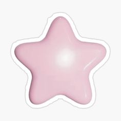 a pink star sticker sitting on top of a white surface with a shadow over it