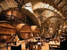 an old wine cellar with wooden barrels and tables